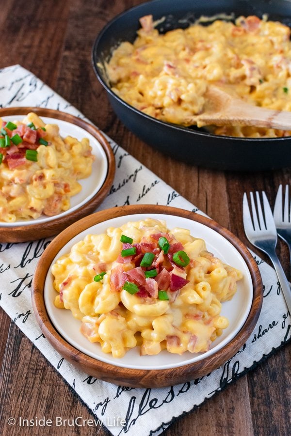 Two plates filled with cheesy macaroni noodles.