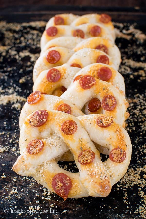 A pan with homemade pretzels covered with mini pepperonis.