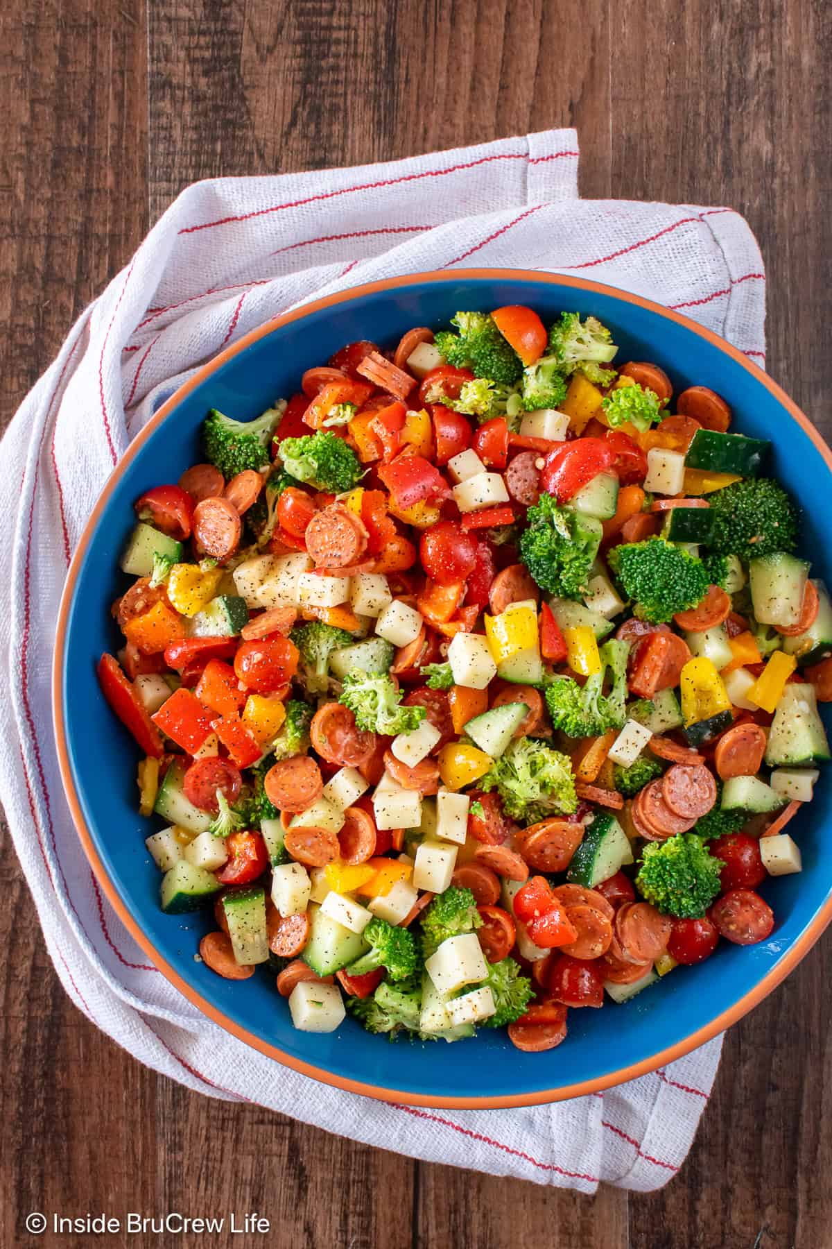 A large blue bowl filled with a chopped Italian veggie salad.