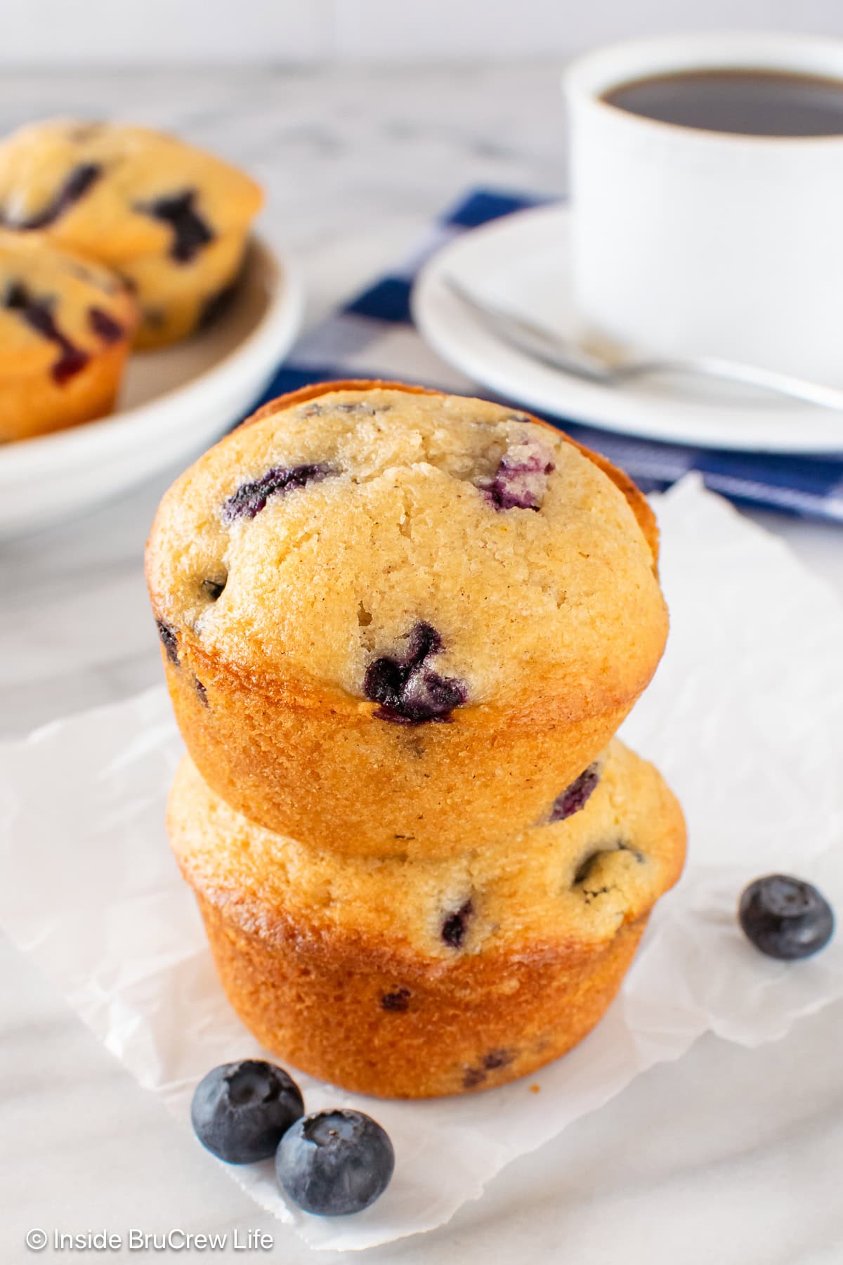 Two blueberry muffins stacked on each other.