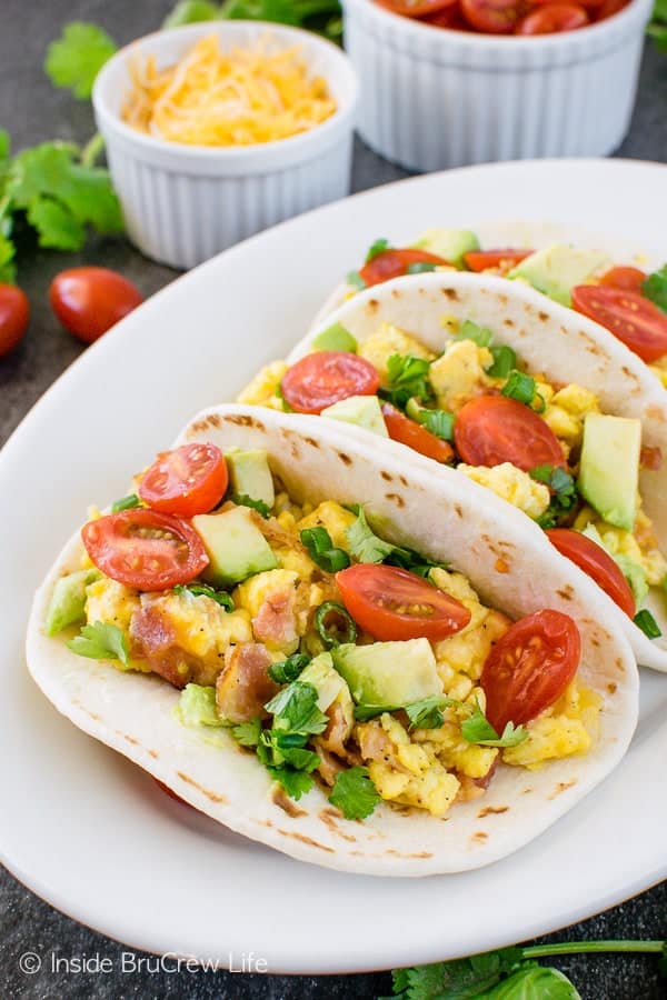Bacon Egg Breakfast Tacos - cheesy eggs with bacon, tomatoes, and avocados are a great way to start the day. Great healthy recipe for breakfast!