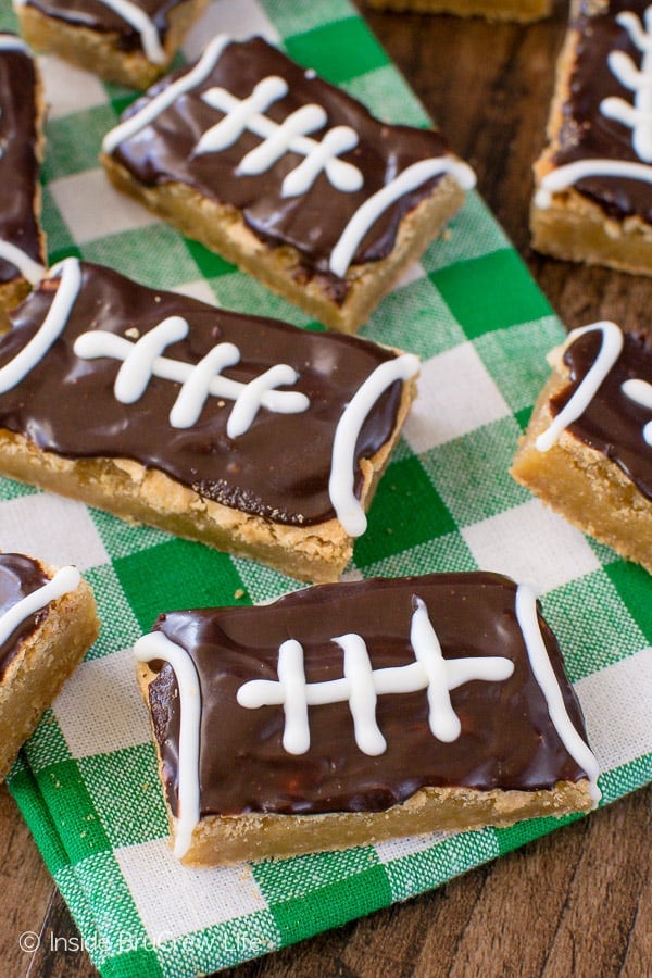 A white and green towel with football cookie bars on top of it