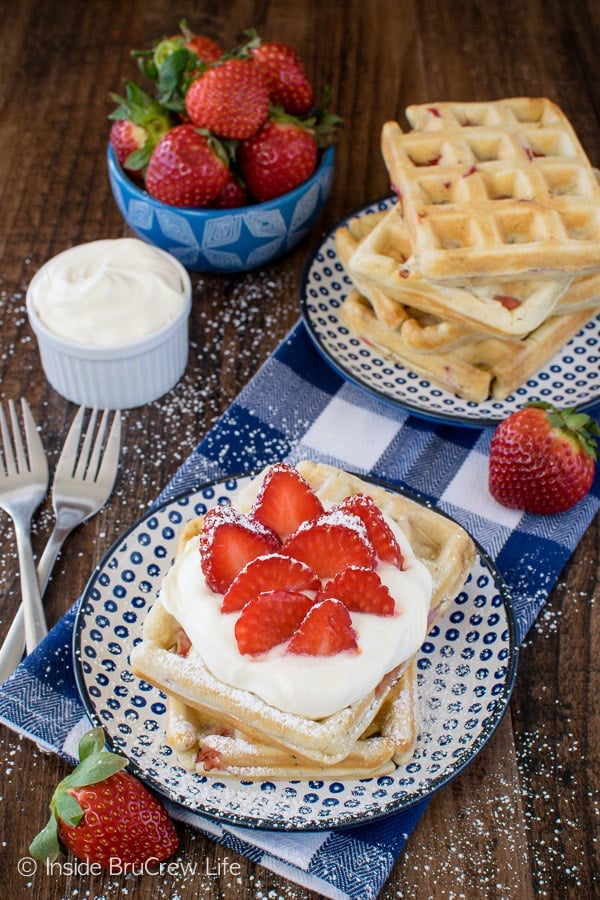 Homemade Strawberry Waffles - these easy waffles are full of fresh berries! Top them with lemon cream and powdered sugar for a fun breakfast recipe!