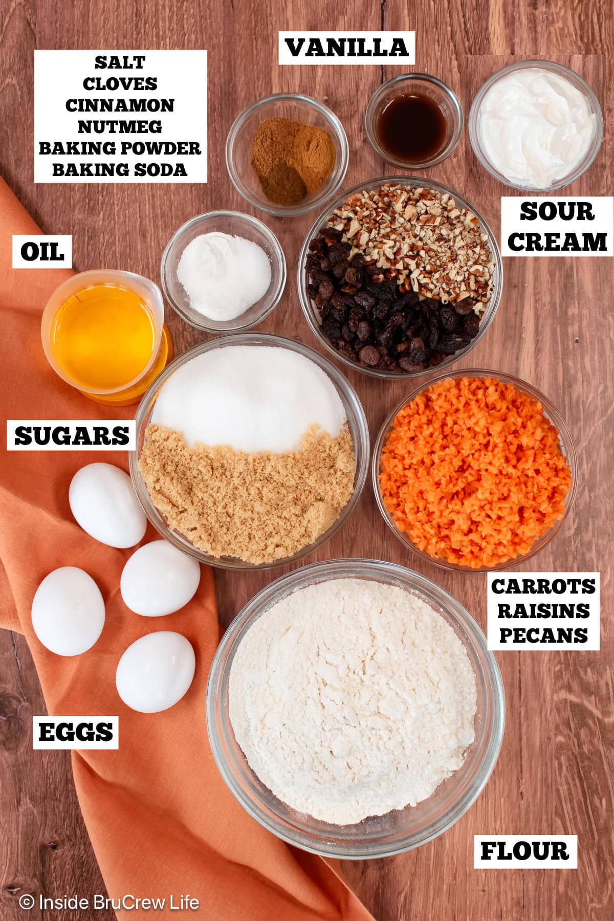 Bowls of ingredients needed to make a carrot cake.