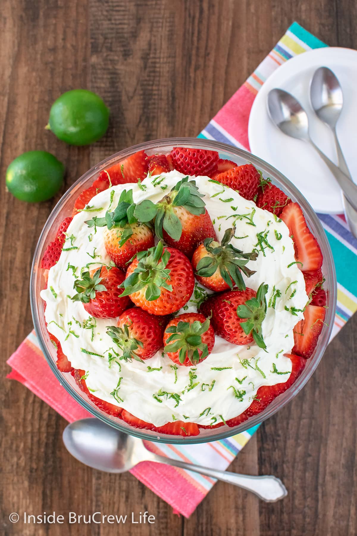 Overhead picture of a trile topped with Cool Whip and strawberries.