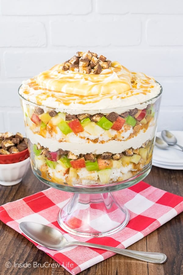 Apple Snickers Cheesecake Trifle - layers of apples, candy bars, and cheesecake make this a show stopper. Great no bake dessert for summer picnics or dinners!