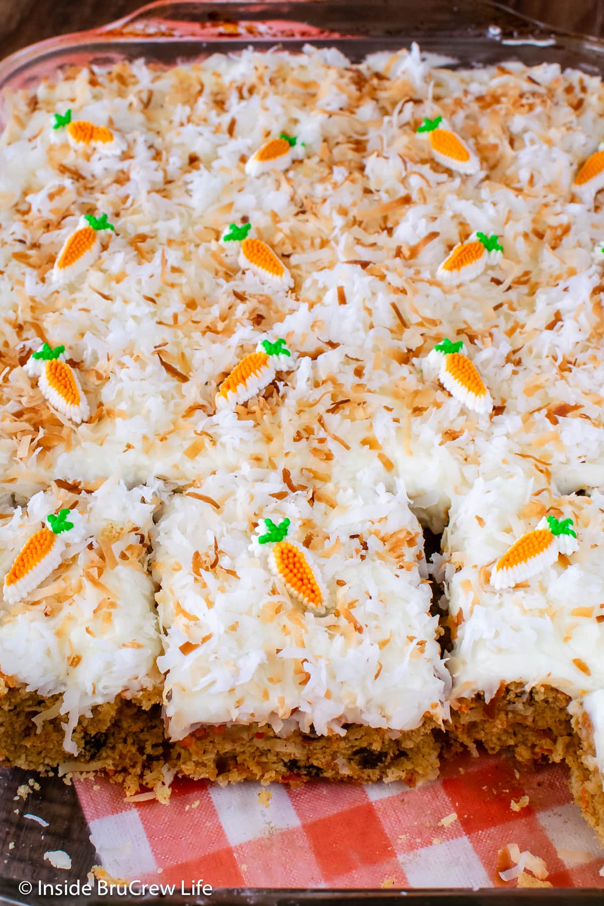 A pan of cake with frosting and toasted coconut.