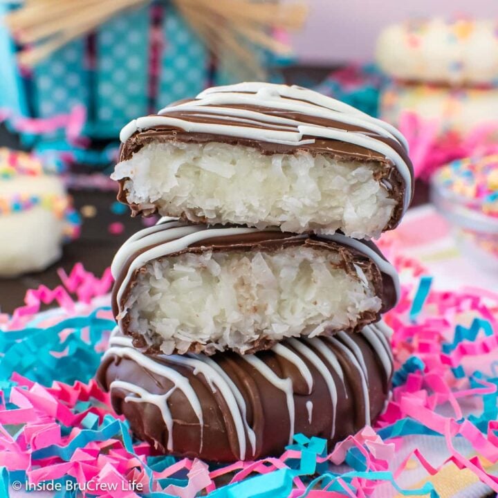 A stack of chocolate covered coconut eggs on a towel.