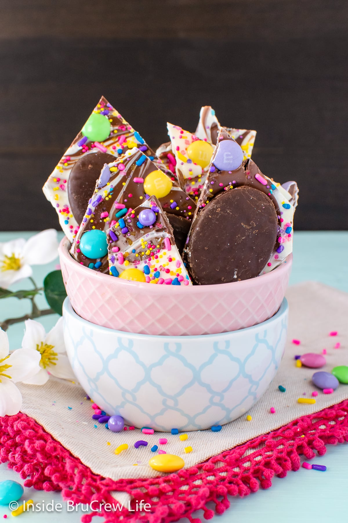 A small bowl filled with chunks of chocolate Easter bark.