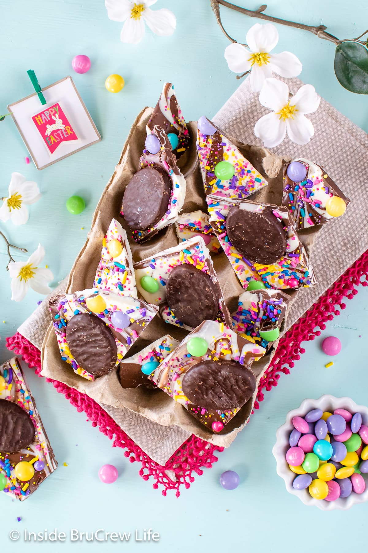 A box of chocolate bark topped with Easter candy.