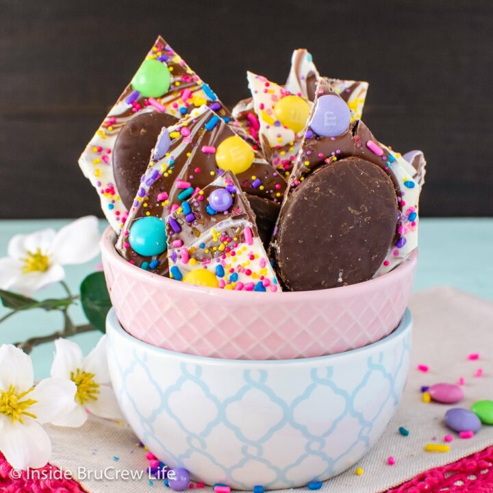 A small bowl filled with chunks of chocolate Easter bark.