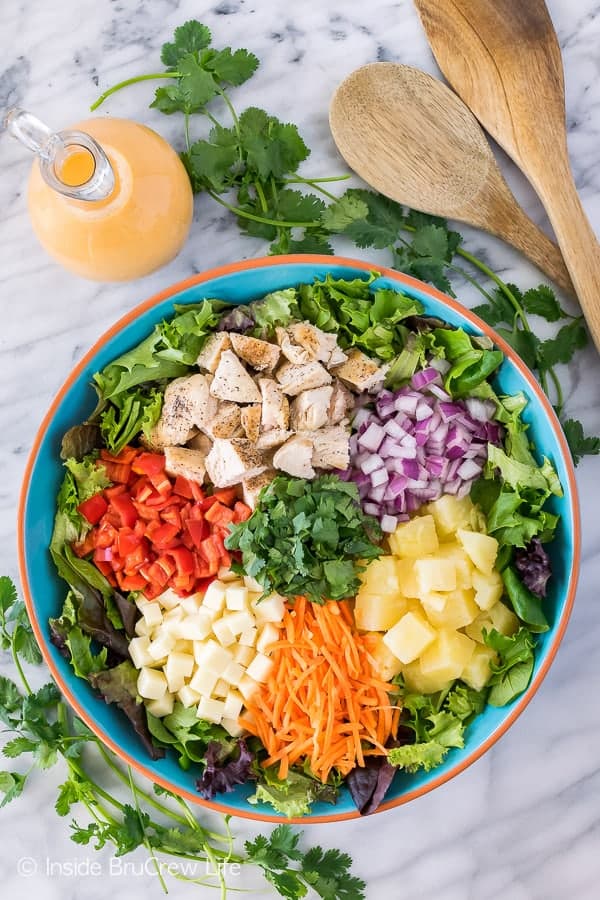 Pineapple Sriracha Chicken Salad - the homemade dressing gives this easy dinner salad a sweet and spicy kick! Great healthy dinner recipe for hot summer days!