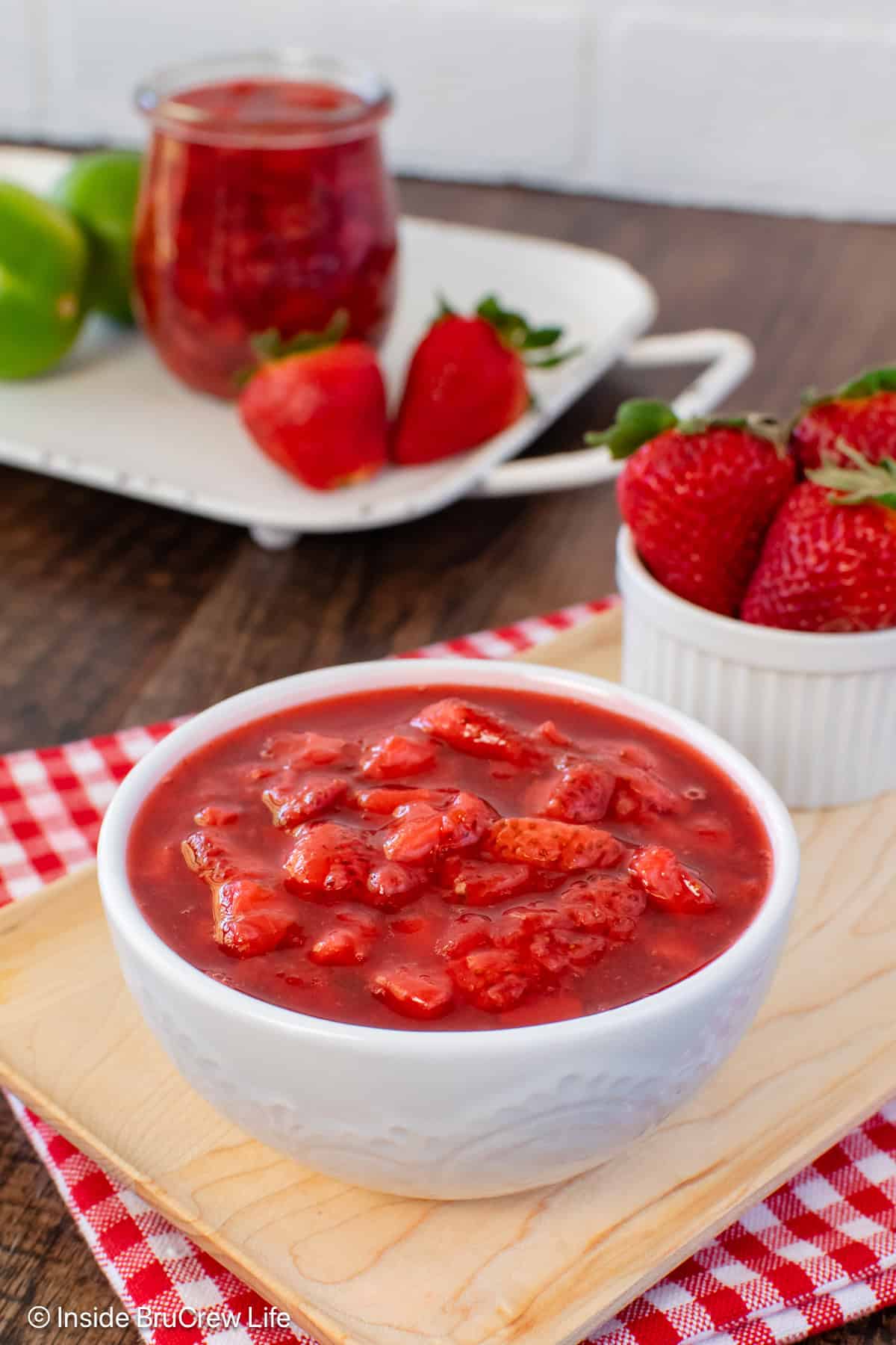 A white bowl filled with a red strawberry sauce.