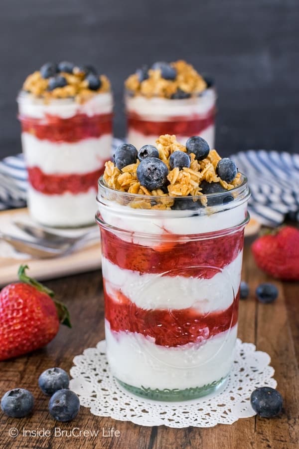 Healthy Strawberry Yogurt Parfaits - layers of Greek yogurt, granola, and homemade strawberry sauce is a great way to start the day. Easy breakfast recipe!