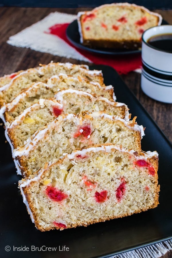 Six slices of tropical banana bread lying on a black plate