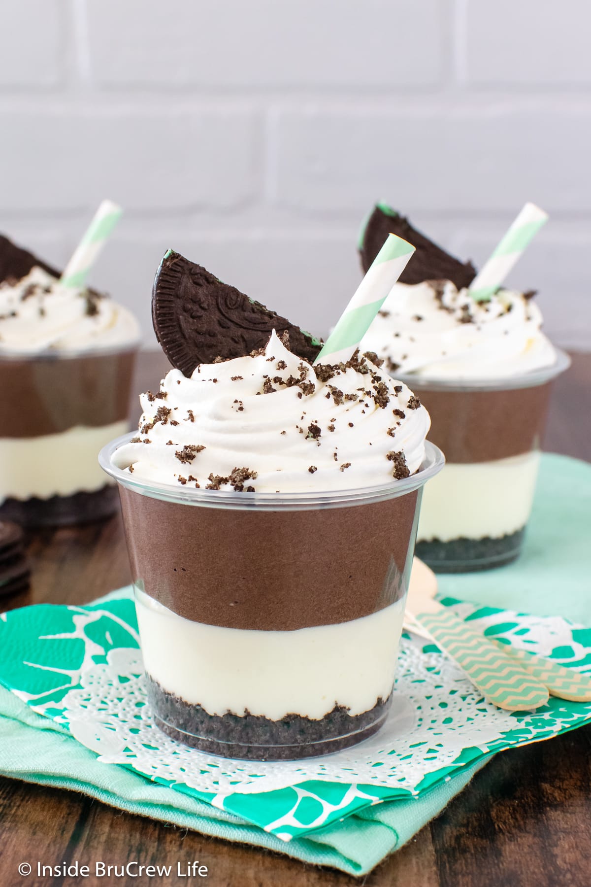 Mint parfait cups filled with two layers of no bake cheesecake.