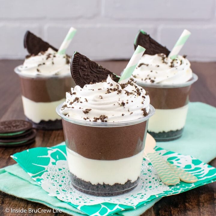 Three clear cups filled with mint and chocolate filling.