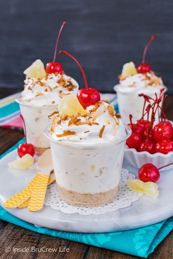 No Bake Pina Colada Cheesecake Parfaits - these easy cups are full of creamy cheesecake full of pineapple and coconut goodness. Easy recipe for summer picnics and parties!