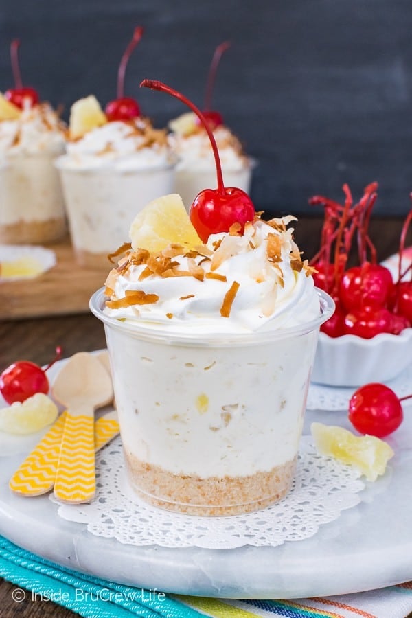 No Bake Pina Colada Cheesecake Parfaits - creamy pineapple and coconut cheesecake in a cute little cup makes a fun summer dessert. Easy recipe for picnics or parties!