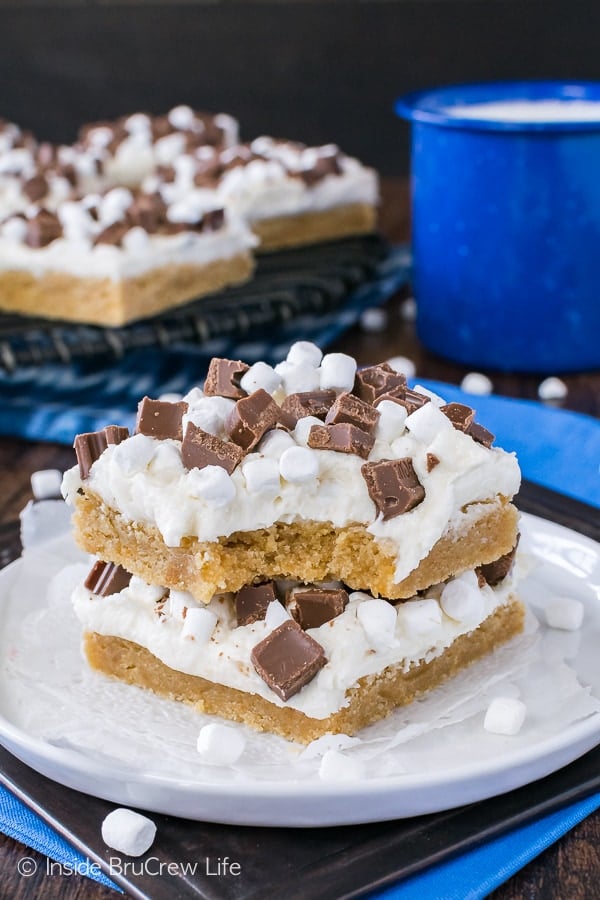 S'mores Sugar Cookie Bars - easy graham cracker cookies topped with marshmallow frosting and chocolate. Easy recipe for summer!