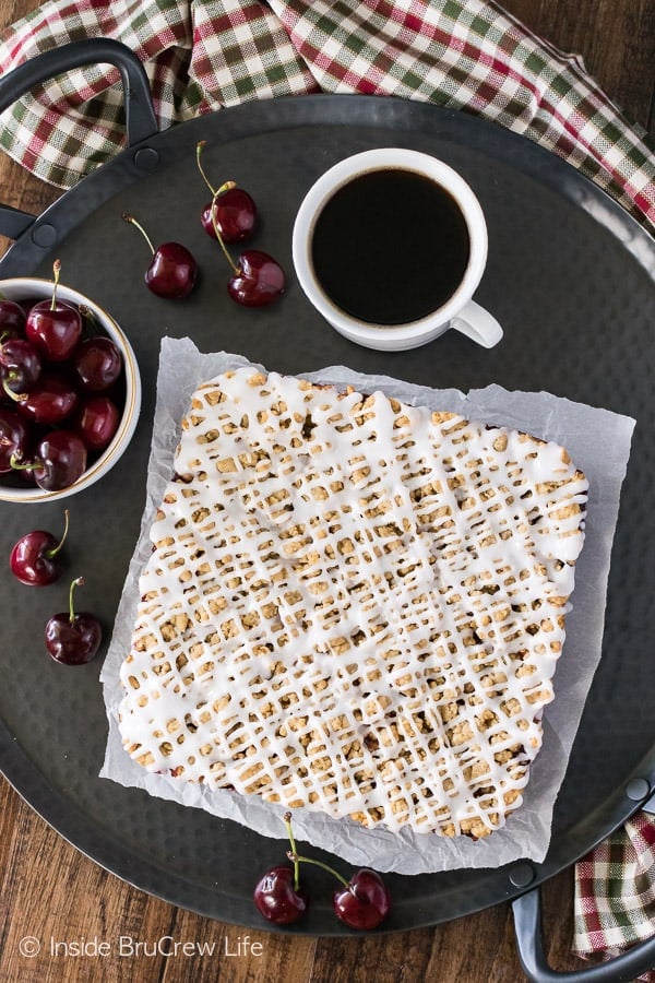 Cherry Apple Crumble Bars - spice crumbles, fruit filling, and a glaze make these a fun summer dessert! Great recipe for picnics!