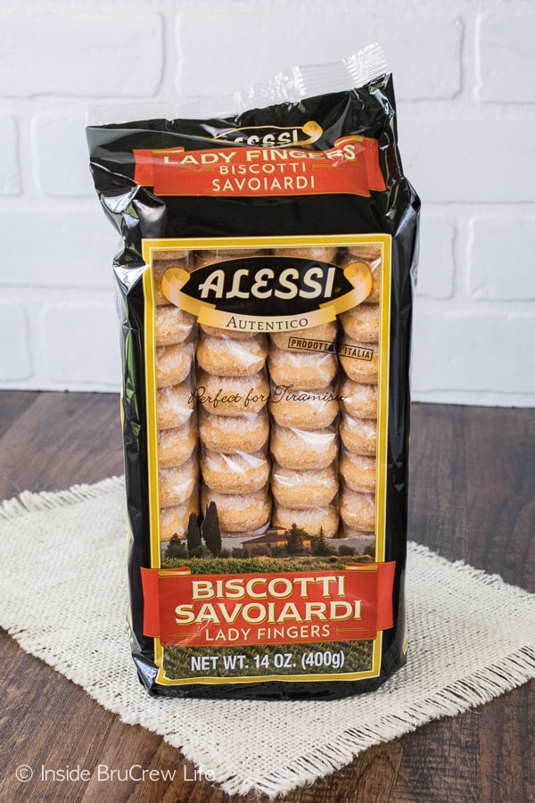 A package of crispy biscotti lady fingers on a wooden board.