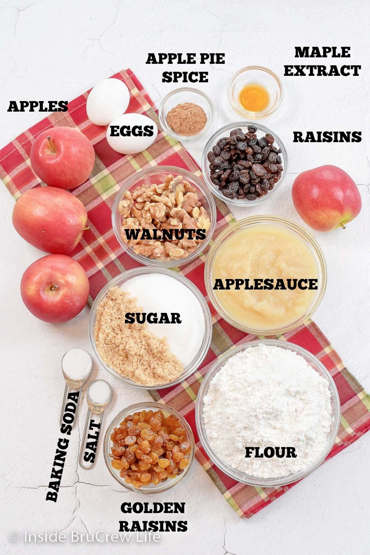 Bowls of ingredients on a white board ready to make an apple cake.