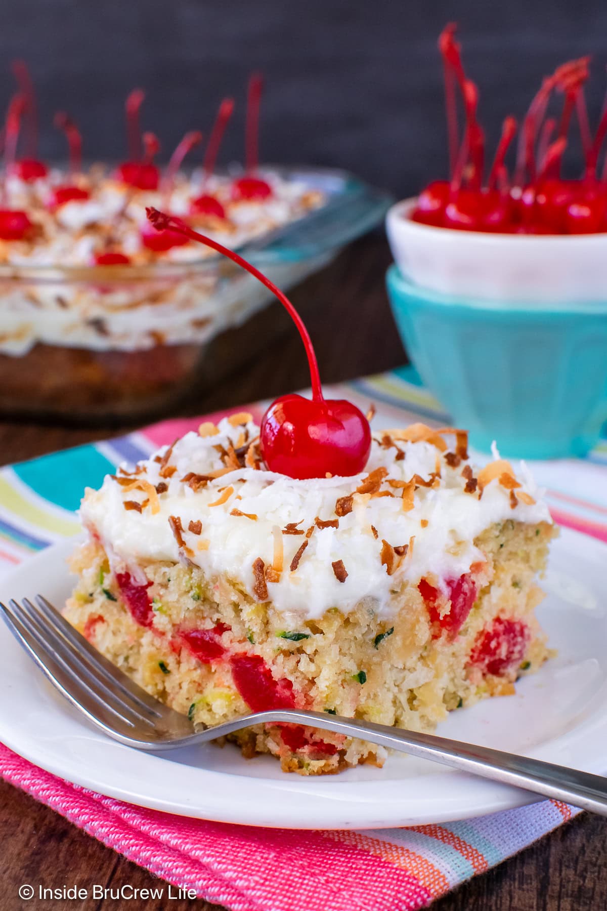 A square of frosted zucchini cake made with pineapple and coconut.