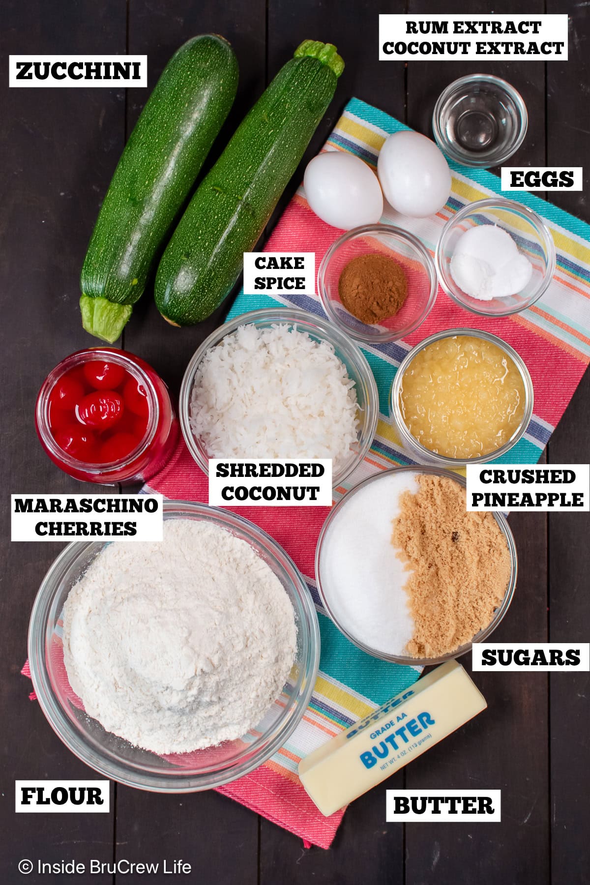 Bowls of ingredients needed to make a tropical zucchini cake.