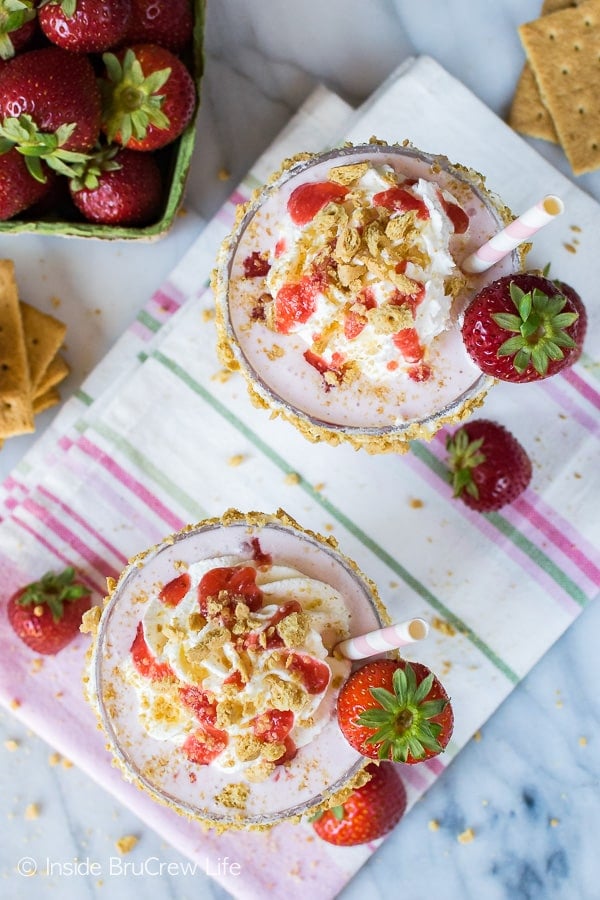 Strawberry Cheesecake Milkshakes - swirls of milkshake, strawberry sauce, and graham cracker crumbs makes a delicious frozen drink. Great summer dessert recipe!