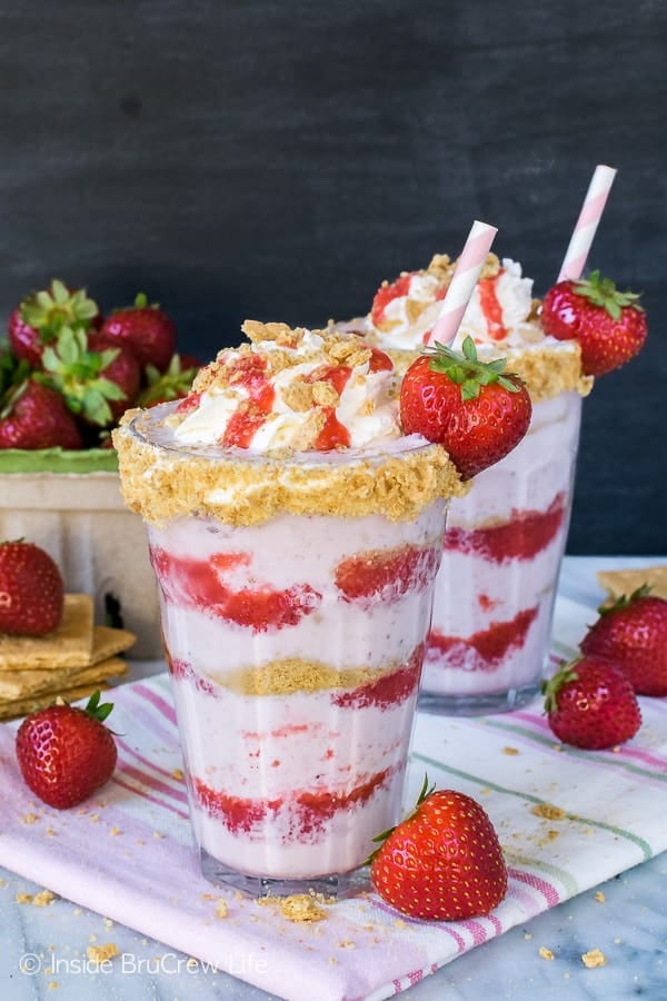 Strawberry Cheesecake Milkshakes - layers of strawberry sauce, milkshake, and graham cracker crumbs makes one amazing frozen drink. Great summer drink recipe!