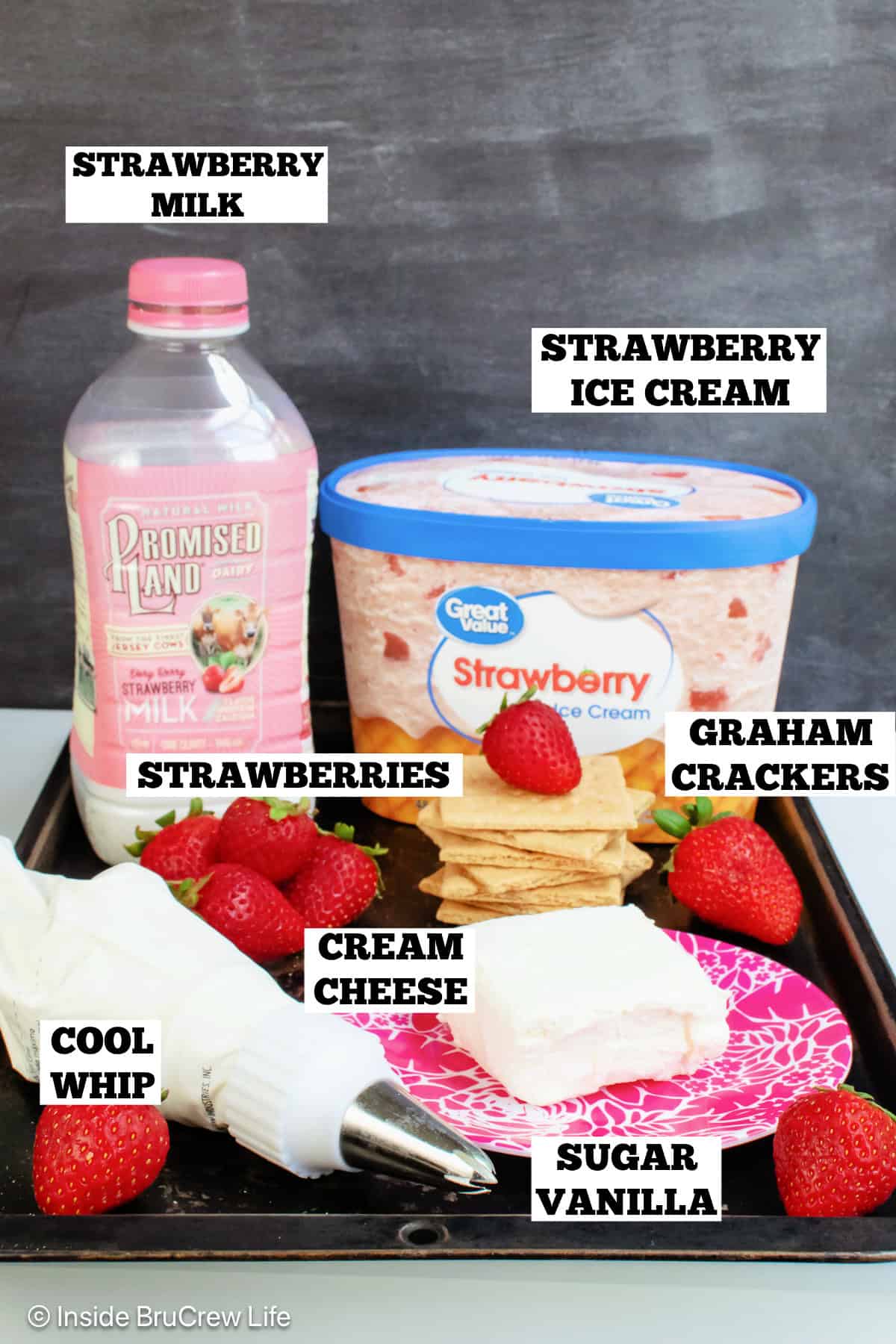Ingredients for a strawberry cheesecake milkshake with text labels.