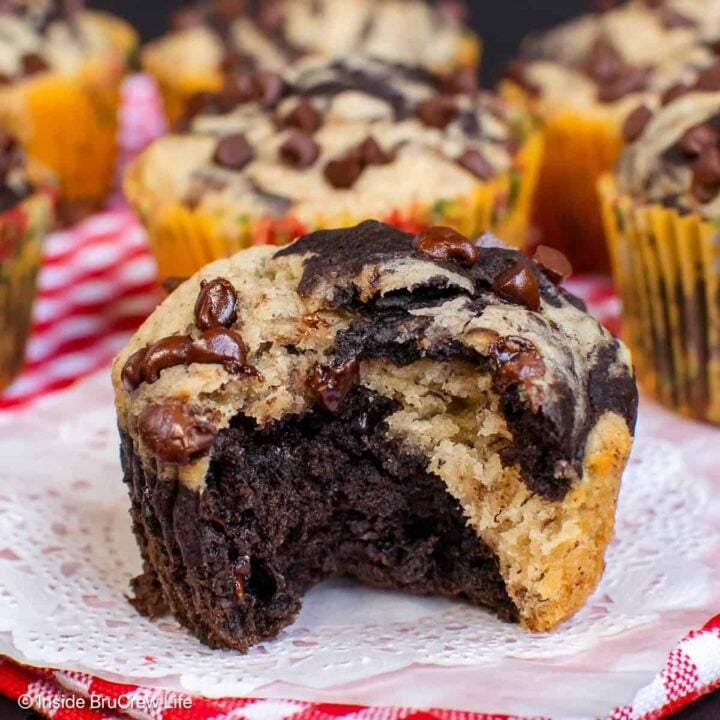 A banana marble muffin with a bite taken out so you can see the swirls inside.
