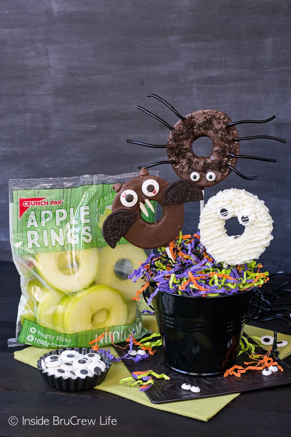 Chocolate Dipped Halloween Apple Rings - candy eyes and cookies add a fun twist to these chocolate dipped apples. Easy no bake recipe for Halloween parties!