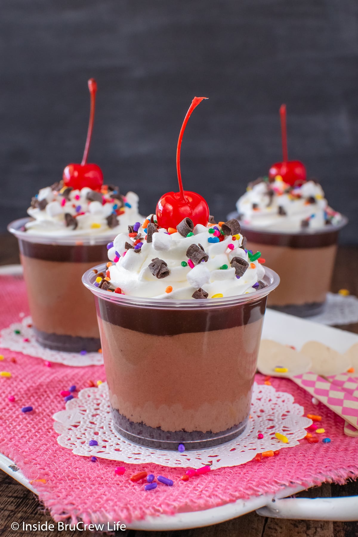 Three mini cups filled with chocolate layers.