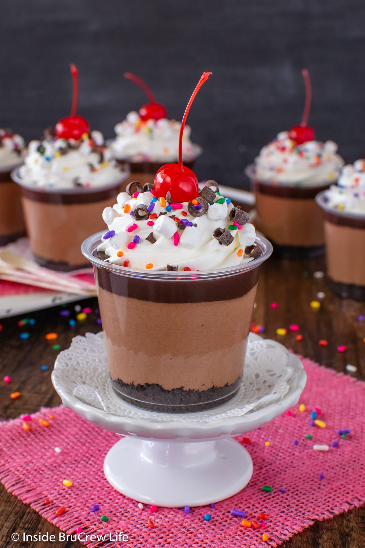 Chocolate mousse layered in little plastic cups.