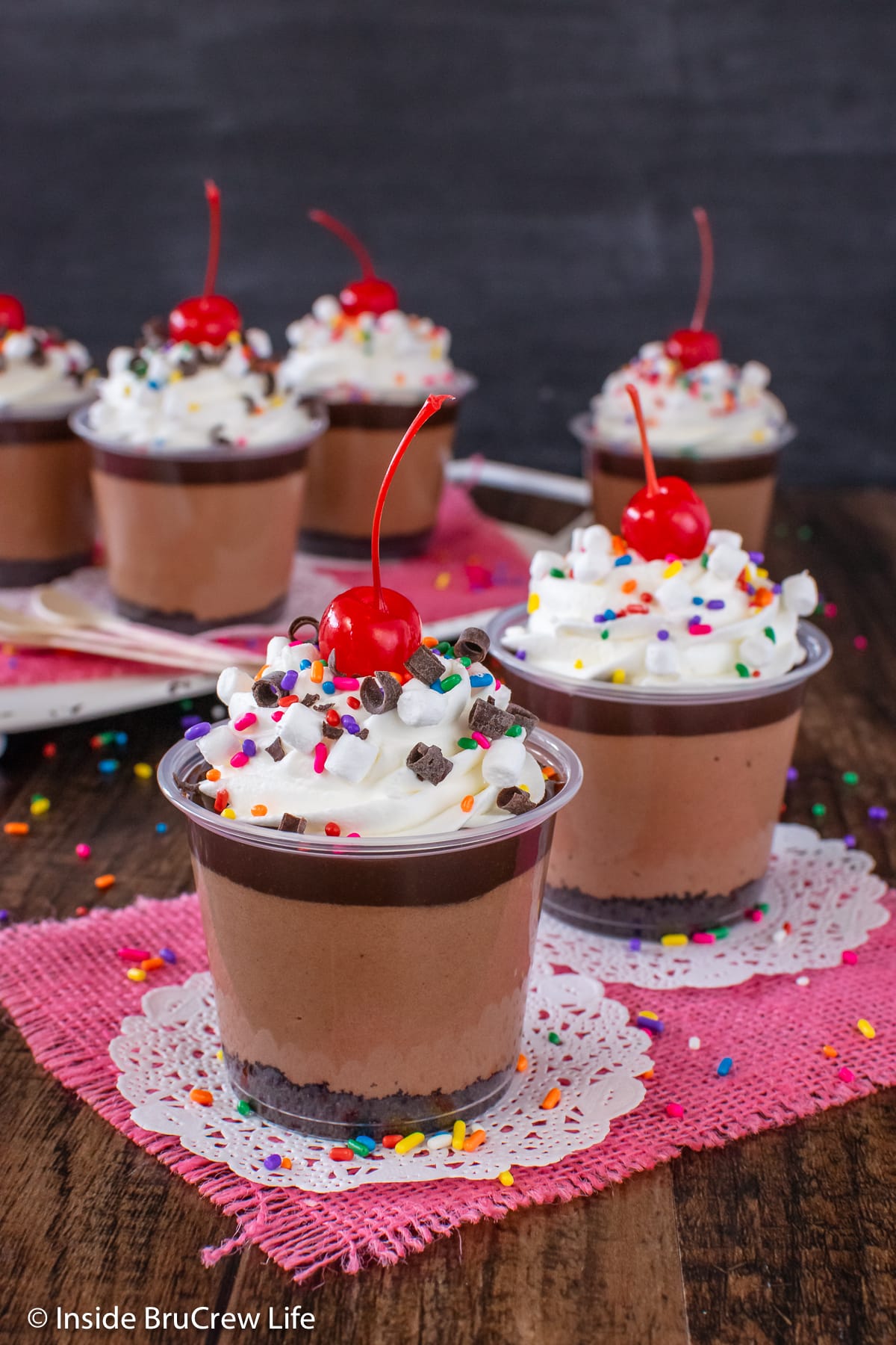 Little mini cups filled with layers of cookies, mousse, and hot fudge.
