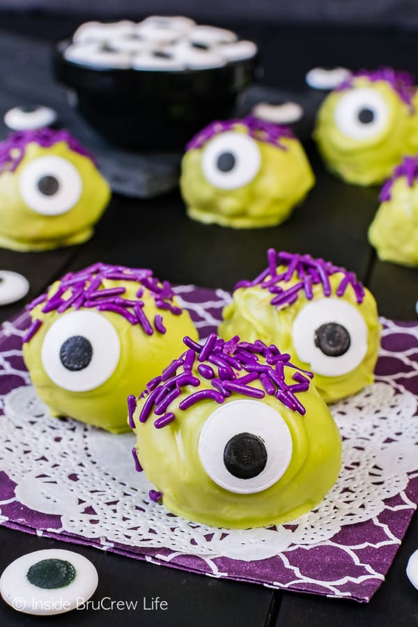 Peanut Butter Monsters - green candy melts, purple sprinkles, and candy eyes turn these easy candies into a fun halloween treat. Easy no bake recipe!