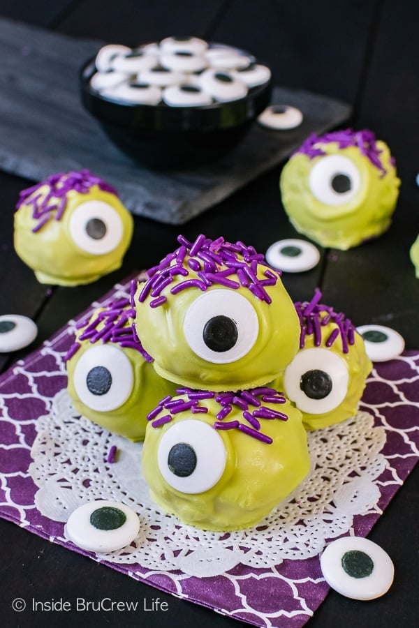 Peanut Butter Monsters - green chocolate, candy eyes, and purple sprinkles turn these easy candies into a fun treat. Easy no bake recipe for halloween parties! 