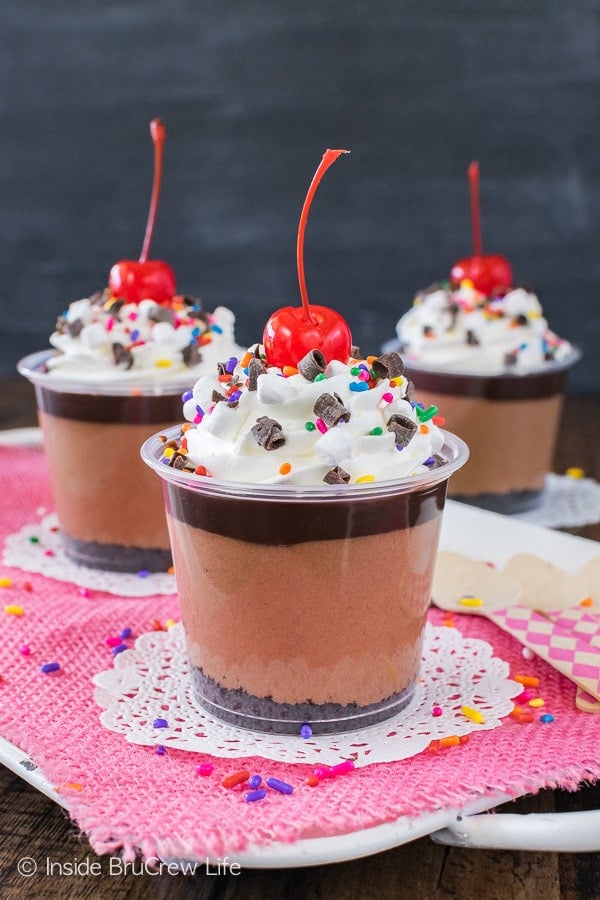 No Bake Triple Chocolate Cheesecake Parfaits - sprinkles, cherries, and three layers of chocolate make these a fun dessert cup! Easy no bake recipe to make for any party!