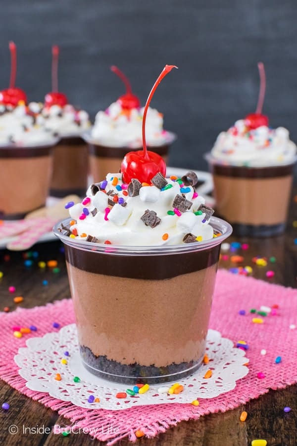 No Bake Triple Chocolate Cheesecake Parfaits - three layers of chocolate, sprinkles, and a cherry make these a fun treat to celebrate anything with. Easy no bake recipe!