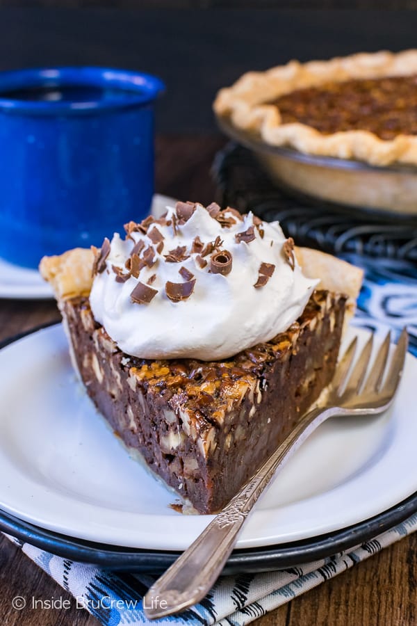 Chocolate Fudge Pecan Pie - toasted nuts and gooey hot fudge add an amazing flavor to this pie. Easy recipe to make ahead of time for Thanksgiving day dinner!