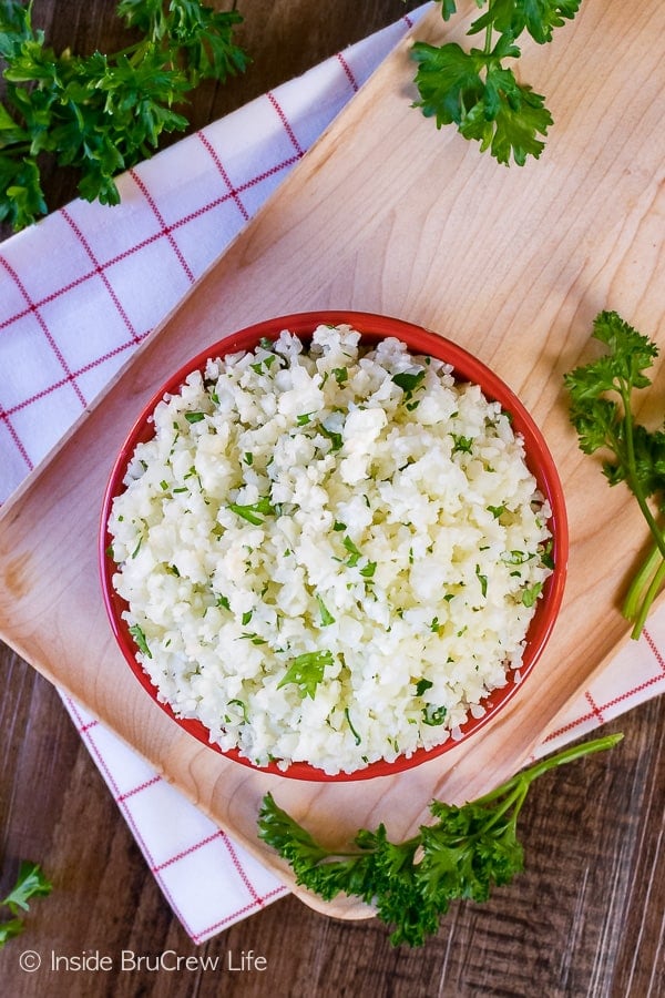 Overhead picture of a red bowl filled with white cauliflower rice.