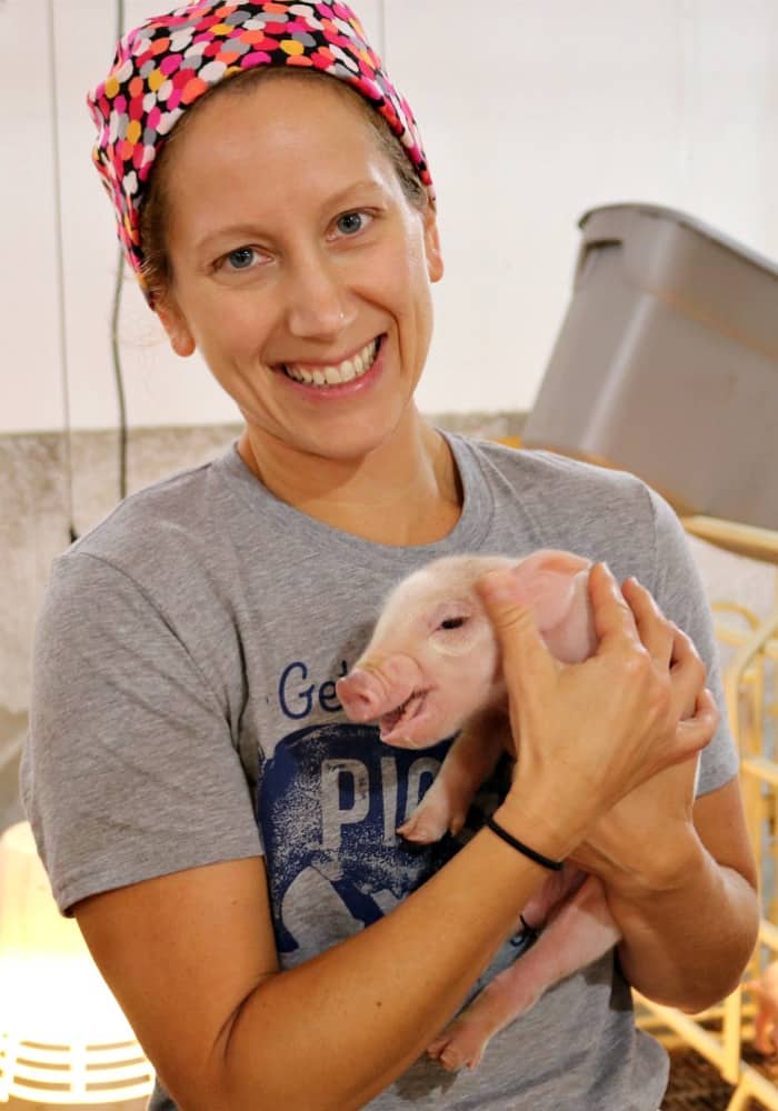 Holding a piglet at the Pass the Pork tour in Sioux Falls, South Dakota