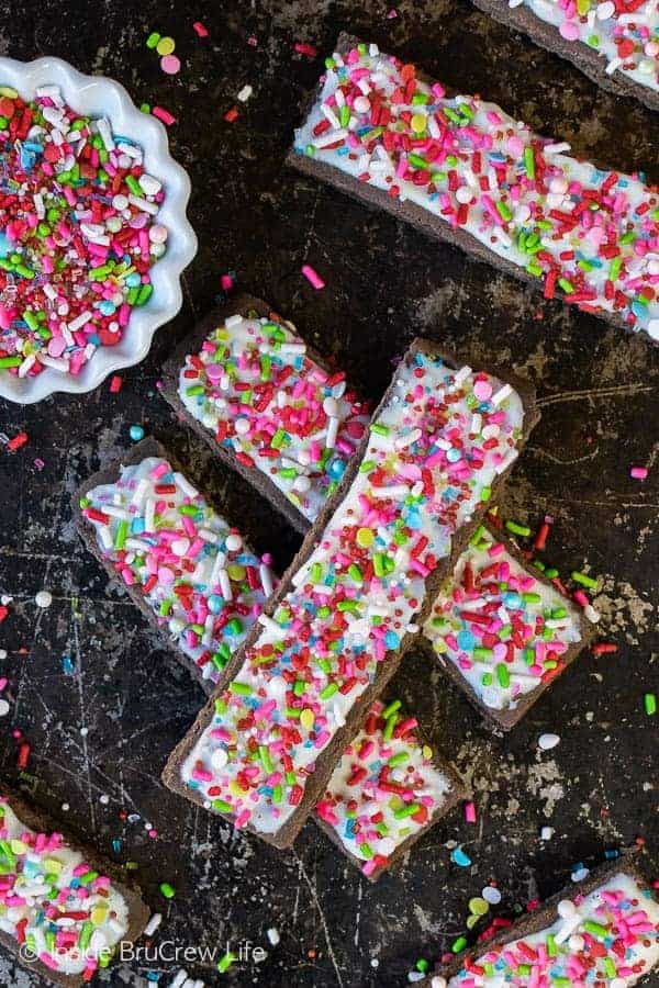 Frosted Mocha Shortbread Cookie Sticks - sweet chocolate cookies topped with white chocolate and lots of sprinkles will stand out on your cookie trays. Easy recipe for holiday parties!