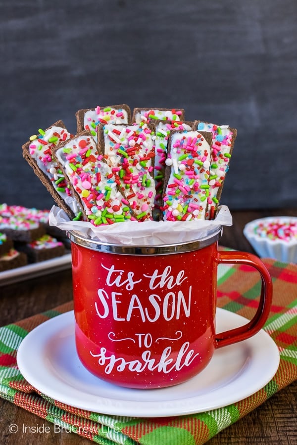 Frosted Mocha Shortbread Cookie Sticks - mocha flavored cookies topped with white chocolate and lots of sprinkles will stand out on your holiday cookie trays. Easy recipe to make for Christmas parties!