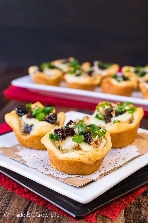 2 crescent roll appetizers on a white plate.