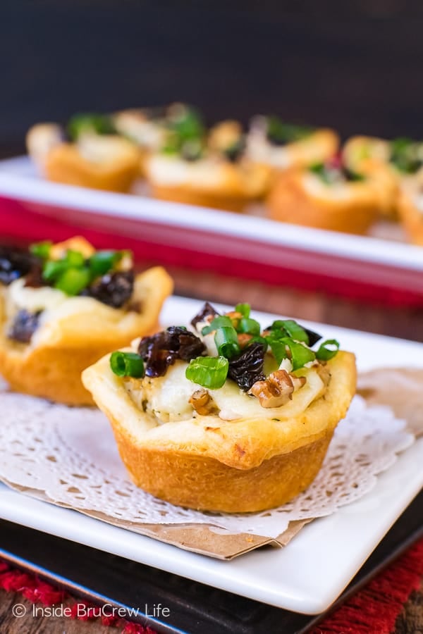 A close up picture of a crescent roll cup stuffed with chicken salad.