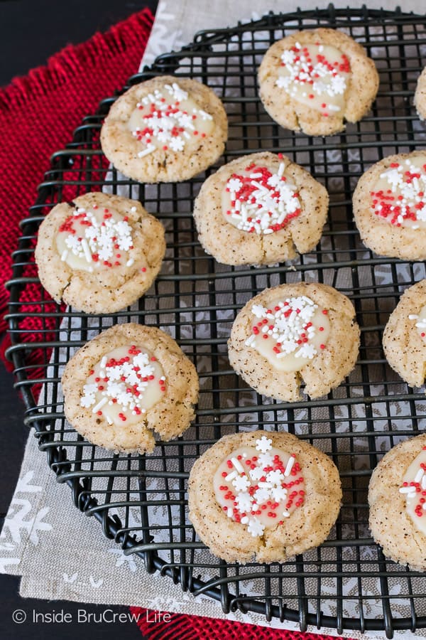 A round wire rack filled with Eggnog Thumbprint cookies.