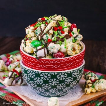 Two stacked bowls filled with chocolate covered Grinch popcorn in it.